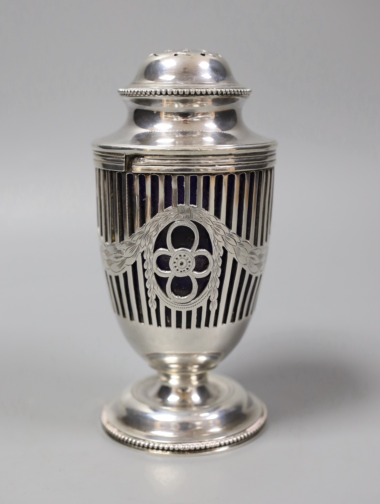 An Edwardian pieced silver vase shaped sugar caster, by Elkington & Co, London, 1909, with blue glass liner, height 14.9cm.